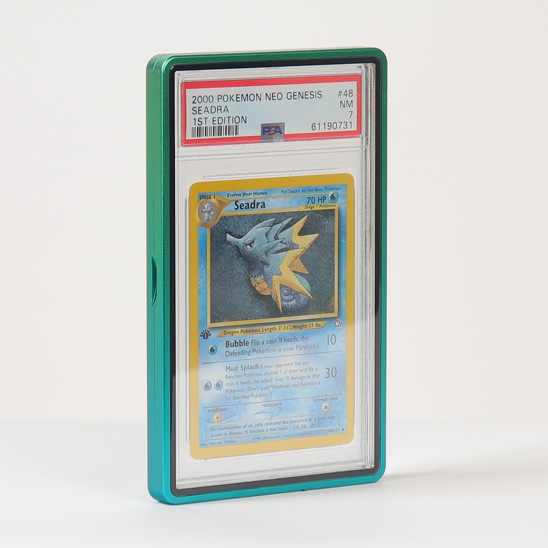 A graded Pokémon TCG card in a clear PSA-style slab with a teal-green protective case, standing upright on a white surface against a white background.