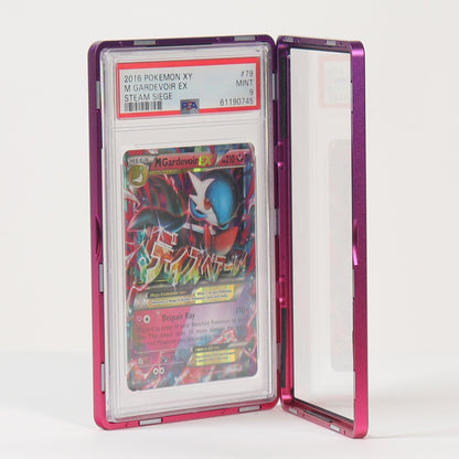 A graded collectible card in a clear plastic slab with a pink metallic frame, standing open on a white surface against a white background.