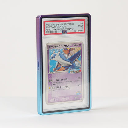A graded Pokémon TCG card in a clear PSA-style plastic slab, standing upright on a white surface against a white background. The card features artwork of a blue bird-like creature and has a purple-toned border visible around the slab.