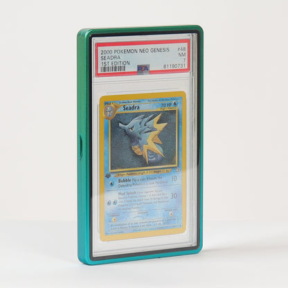 A graded Pokémon TCG card in a clear PSA-style slab with a teal-green protective case, standing upright on a white surface against a white background.