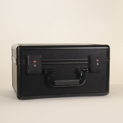 Black suitcase with a handle on a beige background