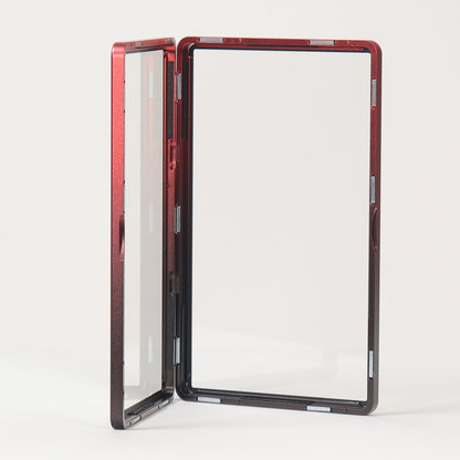 A small rectangular folding mirror with a red and black marbled frame, standing open on a white surface against a light gray background.
